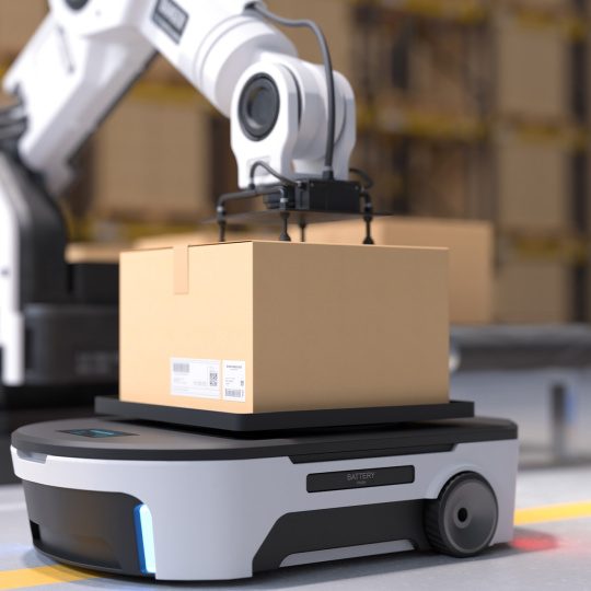 ロボットアームが段ボール箱を自走式ロボットに載せる。